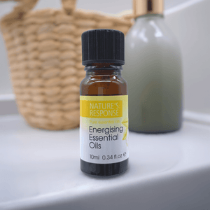 Natures Response tea tree essential oil 10ml amber glass bottle on bathroom sink with wicker basket