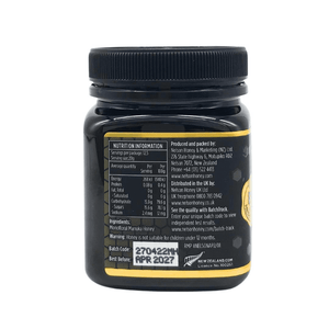 Back of black jar of Nelsons Manuka honey showing nutrition label batch code and Nelson Manuka honey MGO 850+