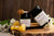Manuka honey jars with honeycomb and wooden dipper on rustic board Best Raw Organic Manuka Honey UK Traceable Certified Genuine