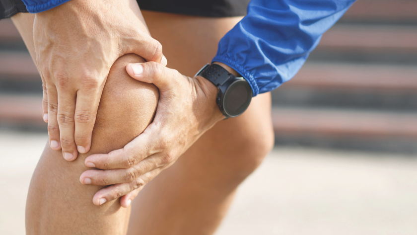 Person holding their Knee in pain