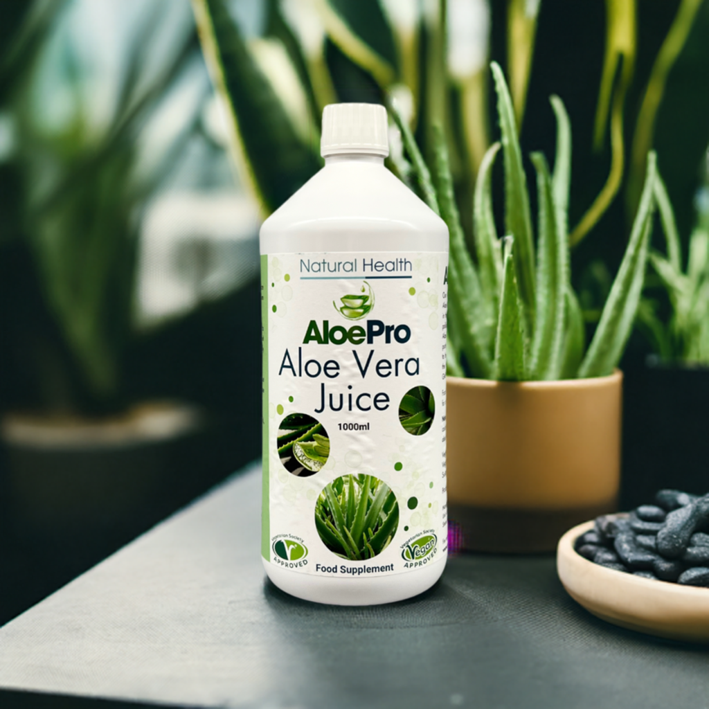 AloePro aloe vera juice 1000ml bottle by Manuka Honey Direct with fresh aloe plants in the background