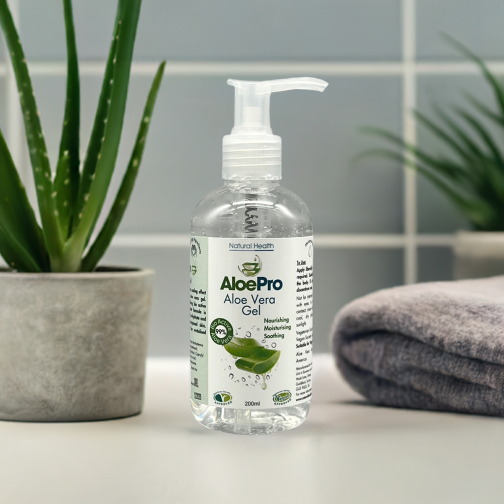 Manuka Honey Direct AloePro aloe vera gel for skin in clear pump bottle with aloe plant and folded towel