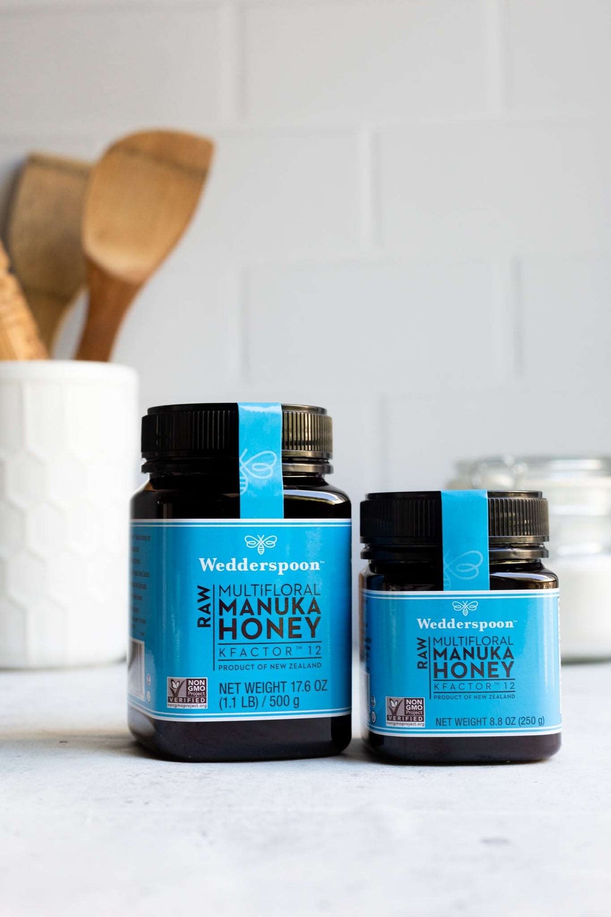 Wedderspoon Raw Manuka honey KFactor 12 jars in different sizes on kitchen countertop