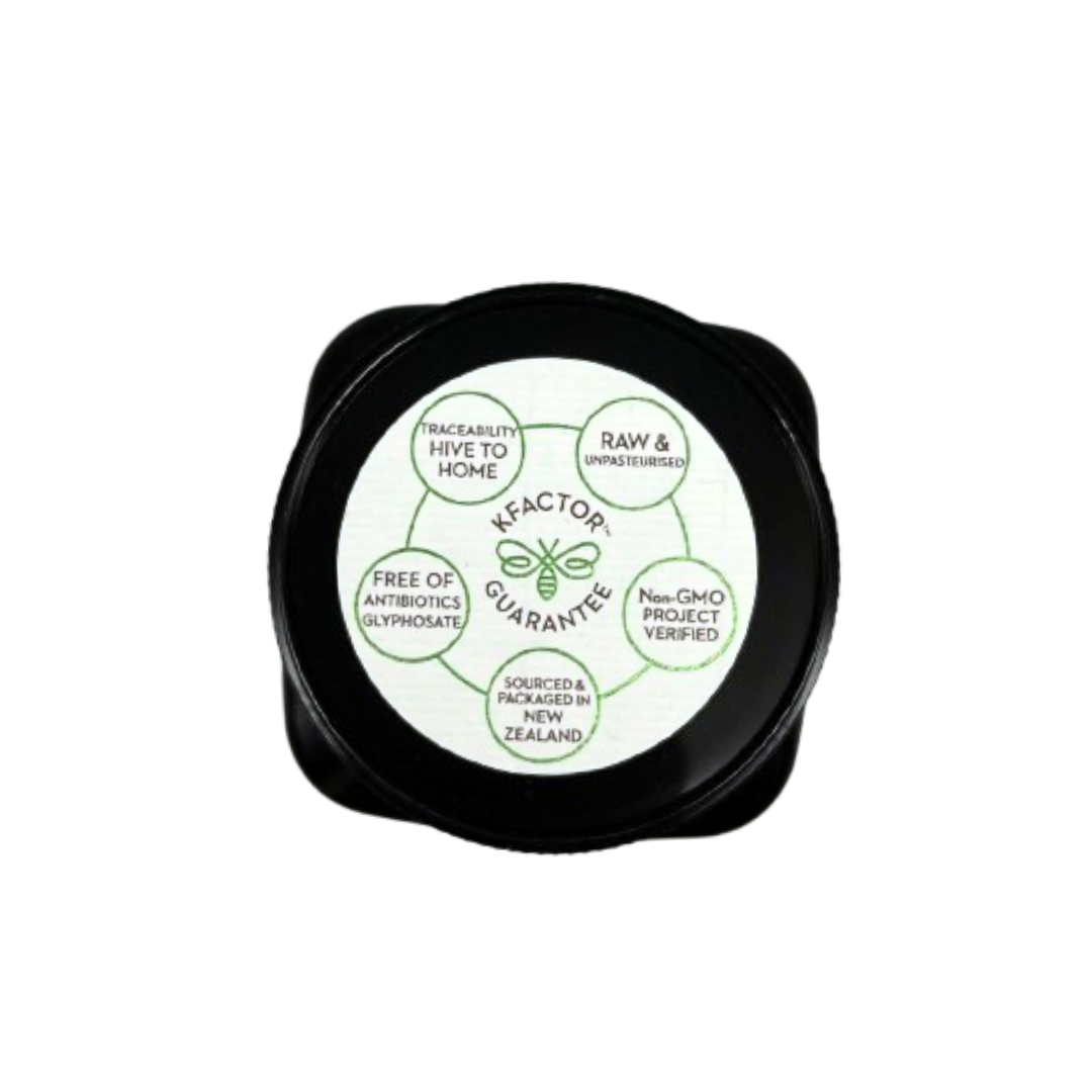 Close-up of Wedderspoon Organic Raw Manuka Honey 400 MGO 250g black lid showing certification labels