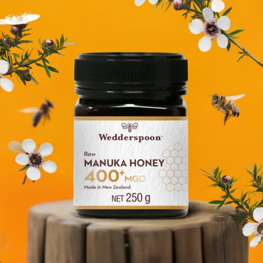 Wedderspoon Raw Manuka Honey 400 MGO 250g Unpasteurised jar with bees and flowers on orange background