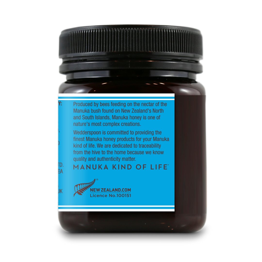 Wedderspoon Raw Manuka honey KFactor 12 jar with black lid and blue label showing product information